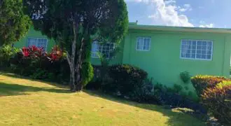 Spacious 6 Bedroom 5 Bathroom split level home sitting on a 1/2 acre estate and overlooking the airport and the Caribbean sea